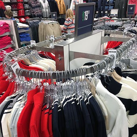 A rack of assorted apparel in a retail store.