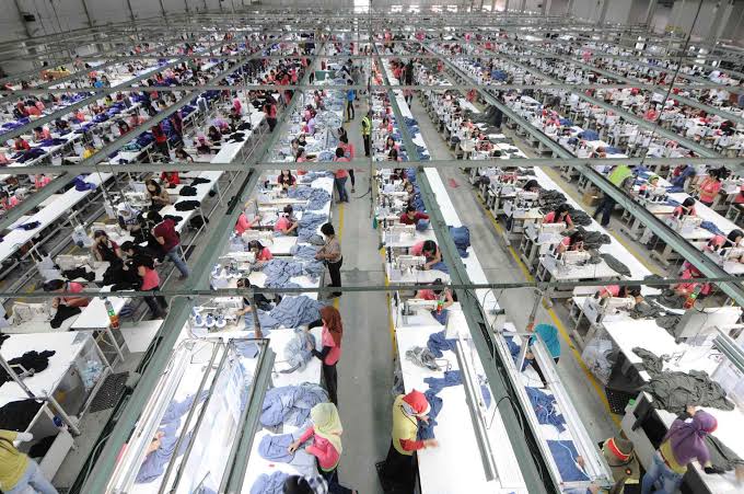 Workers producing garments in a factory.